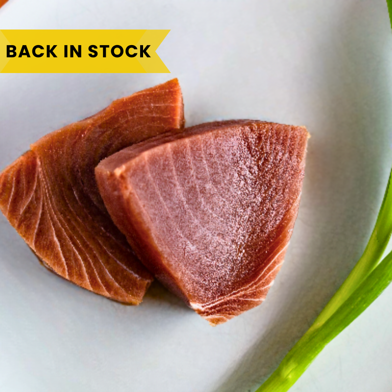 Two slices of raw salmon on a white plate with a yellow banner indicating 'Back in Stock'.